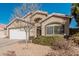 Tan house with white garage door and landscaping at 3854 W Yellow Peak Dr, San Tan Valley, AZ 85144