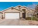 Tan house with white garage door and landscaping at 3854 W Yellow Peak Dr, San Tan Valley, AZ 85144