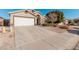 Tan house with white garage door and driveway at 3854 W Yellow Peak Dr, San Tan Valley, AZ 85144