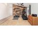 Home gym with wood accent wall, treadmill, and weights at 3854 W Yellow Peak Dr, San Tan Valley, AZ 85144