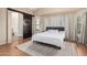 Main bedroom with king bed, wood floors, and bathroom access at 3854 W Yellow Peak Dr, San Tan Valley, AZ 85144