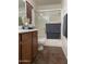 Bathroom with a tub, shower, and wood cabinets at 42244 W Calle St, Maricopa, AZ 85138