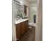 Bathroom with a tub, shower, and wood cabinets at 42244 W Calle St, Maricopa, AZ 85138