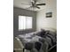 Bedroom with a queen bed and ceiling fan at 42244 W Calle St, Maricopa, AZ 85138