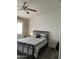 Bright bedroom with a comfortable bed and ceiling fan at 42244 W Calle St, Maricopa, AZ 85138