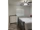Bedroom with white dresser and ceiling fan at 42244 W Calle St, Maricopa, AZ 85138