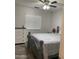 Bedroom with gray bed frame and ceiling fan at 42244 W Calle St, Maricopa, AZ 85138