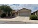 Single-story house with a two-car garage and desert landscaping at 42244 W Calle St, Maricopa, AZ 85138