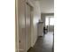 Home hallway with tiled floor and white door at 42244 W Calle St, Maricopa, AZ 85138