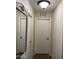 Hallway with laundry room access and mirror at 42244 W Calle St, Maricopa, AZ 85138