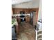 Kitchen with wood cabinets, stainless steel appliances, and tile floors at 42244 W Calle St, Maricopa, AZ 85138