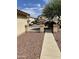 View of a side yard with a walkway and neighboring homes at 42244 W Calle St, Maricopa, AZ 85138