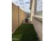 Side yard with artificial turf and air conditioner at 42244 W Calle St, Maricopa, AZ 85138