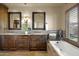 Elegant bathroom with double sinks, granite countertops, and a soaking tub at 6302 E Monte Cristo Ave, Scottsdale, AZ 85254