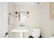 Simple bathroom with pedestal sink, toilet, and oval mirror at 6302 E Monte Cristo Ave, Scottsdale, AZ 85254