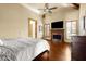Main bedroom with fireplace, hardwood floors, and a ceiling fan at 6302 E Monte Cristo Ave, Scottsdale, AZ 85254