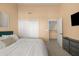 Bright bedroom with king bed, closet, and access to upper level at 6302 E Monte Cristo Ave, Scottsdale, AZ 85254
