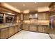Large kitchen with wood cabinets, granite countertops, and stainless steel appliances at 6302 E Monte Cristo Ave, Scottsdale, AZ 85254