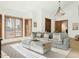 Bright living room with large windows, wood shutters, plush seating and stylish decor at 6302 E Monte Cristo Ave, Scottsdale, AZ 85254