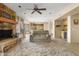 Cozy living room features a stone fireplace and neutral colored couch at 6302 E Monte Cristo Ave, Scottsdale, AZ 85254