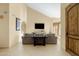 Bright living room featuring a large TV and stone flooring at 6302 E Monte Cristo Ave, Scottsdale, AZ 85254