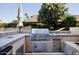 Built-in outdoor kitchen with grill and sink at 6302 E Monte Cristo Ave, Scottsdale, AZ 85254