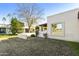 Backyard with grass, trees, and a partial view of a golf course at 649 S Arrowwood Way, Mesa, AZ 85208