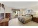 Main bedroom with a king-size bed and access to a patio at 649 S Arrowwood Way, Mesa, AZ 85208