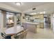 Kitchen with light wood cabinets, breakfast bar and view into dining area at 649 S Arrowwood Way, Mesa, AZ 85208