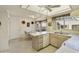 Galley kitchen with light wood cabinets, breakfast nook, and window views at 649 S Arrowwood Way, Mesa, AZ 85208