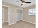 Bright bedroom with ceiling fan, window, and walk-in closet at 7607 N 42Nd Ln, Phoenix, AZ 85051