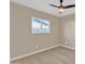 Spacious bedroom with ceiling fan, large window, and wood-look flooring at 7607 N 42Nd Ln, Phoenix, AZ 85051