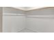 Spacious closet with wood shelving and hanging rod at 7607 N 42Nd Ln, Phoenix, AZ 85051