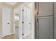 Bright hallway with doors to bedrooms and gray cabinets at 7607 N 42Nd Ln, Phoenix, AZ 85051