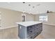 Modern kitchen island with white countertop and gray cabinets at 7607 N 42Nd Ln, Phoenix, AZ 85051
