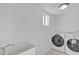 Laundry room with washer, dryer, and utility sink at 7607 N 42Nd Ln, Phoenix, AZ 85051