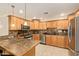 Modern kitchen with wood cabinets, stainless steel appliances, and granite countertops at 8644 E Roanoke Ave, Scottsdale, AZ 85257