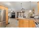 Modern kitchen with island, stainless steel appliances, and view to living room at 8644 E Roanoke Ave, Scottsdale, AZ 85257