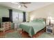 Spacious bedroom with wood floors, ceiling fan, and large window at 9270 W Morrow Dr, Peoria, AZ 85382