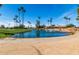 Peaceful golf course scene with a pond and palm trees at 9270 W Morrow Dr, Peoria, AZ 85382