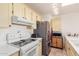 White kitchen features ample counter space and updated appliances at 9270 W Morrow Dr, Peoria, AZ 85382