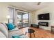 Living room with fireplace and sliding glass doors to patio at 9270 W Morrow Dr, Peoria, AZ 85382