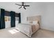 King bedroom with teal curtains and ceiling fan at 9431 E Supernova Dr, Mesa, AZ 85212