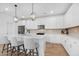 Modern kitchen with white cabinets, quartz countertops, and gold lighting at 9431 E Supernova Dr, Mesa, AZ 85212