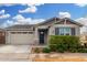 Single story home with a two-car garage and nicely landscaped front yard at 9829 E Tahoe Ave, Mesa, AZ 85212