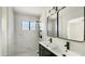 Modern bathroom features a double sink vanity with black fixtures and a tiled walk-in shower at 1036 E Glenn Dr, Phoenix, AZ 85020