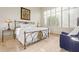 Bright bedroom with a metal bed frame and window shutters at 11003 E Turnberry Rd, Scottsdale, AZ 85255