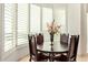 Formal dining area with dark wood table and chairs, and large windows at 11003 E Turnberry Rd, Scottsdale, AZ 85255