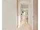 Long hallway with light beige tile floors and wooden doors at 11003 E Turnberry Rd, Scottsdale, AZ 85255