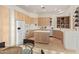 Spacious kitchen with light wood cabinets, an island, and stainless steel appliances at 11003 E Turnberry Rd, Scottsdale, AZ 85255